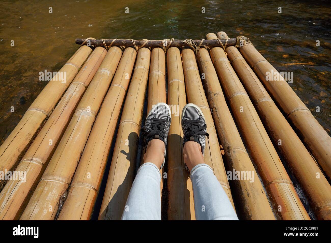 Woman sitting on the bamboo raft floating in clear water Stock Photo ...