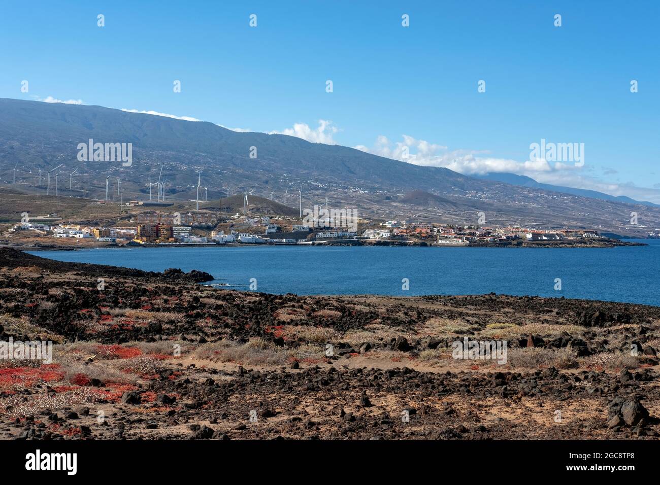 Partial views of Arico municipality from Poris de Abona, with tranquil coastal villages settled on the arid volcanic land and the wind turbines Stock Photo