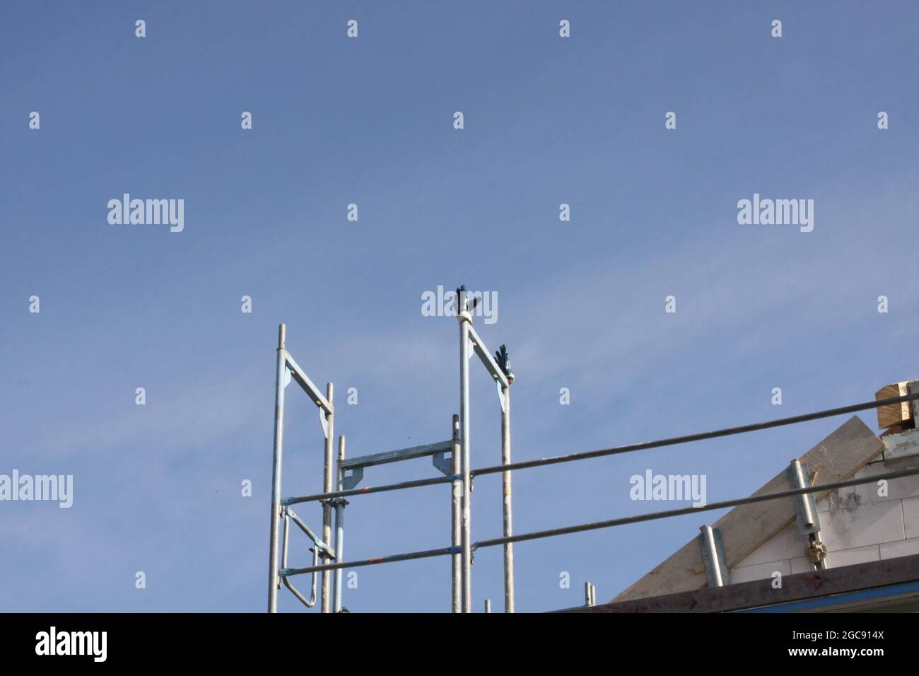 contruction site with gloves left for drying on construction site with blue sky, Nuremberg, Germany Stock Photo