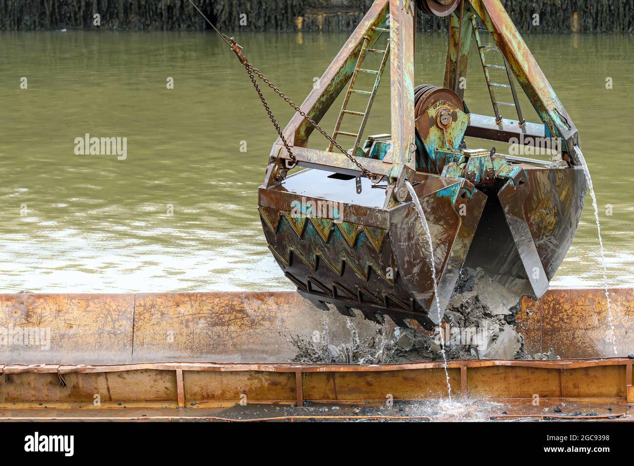 Excavator digging water mud construction hires stock photography and