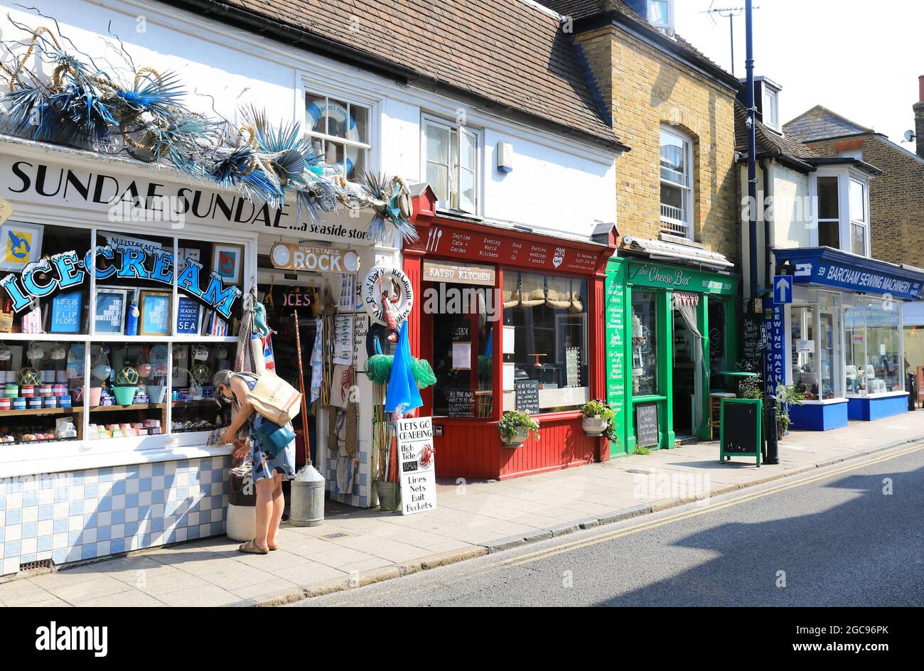 Independent shops and cafes on pretty Harbour Street, in coastal Whitstable, in north Kent, UK Stock Photo