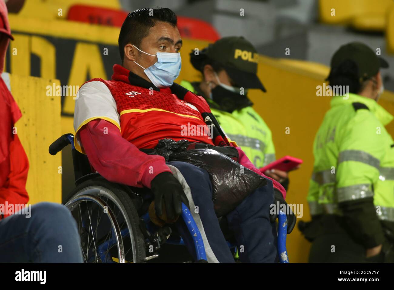 A man in a wheelchair supports his team Independiente Santa Fe in the match against Atletico Nacional, which was played in Bogota Stock Photo