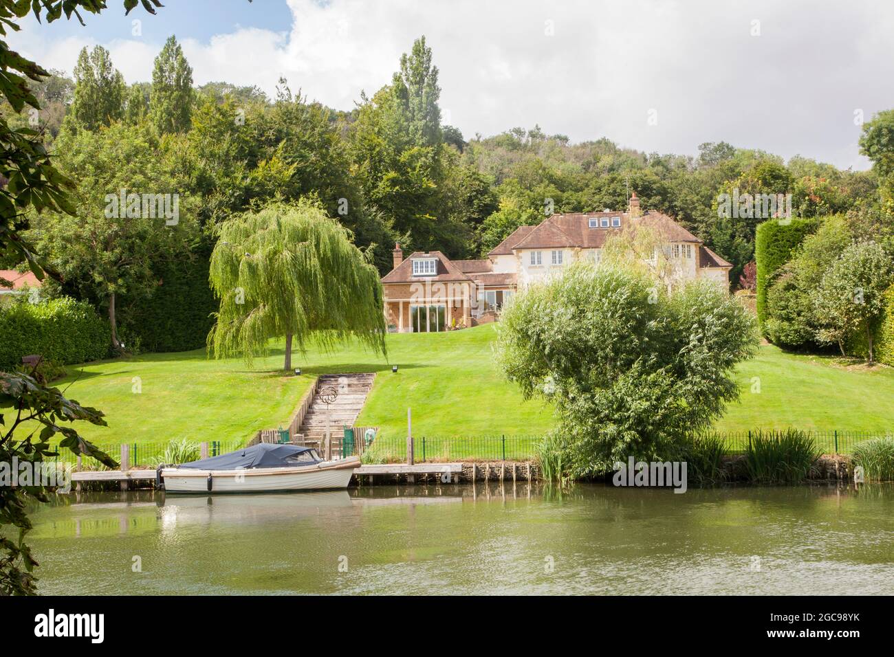 House on the river Thames at Goring on Thames Oxfordshire with a boat