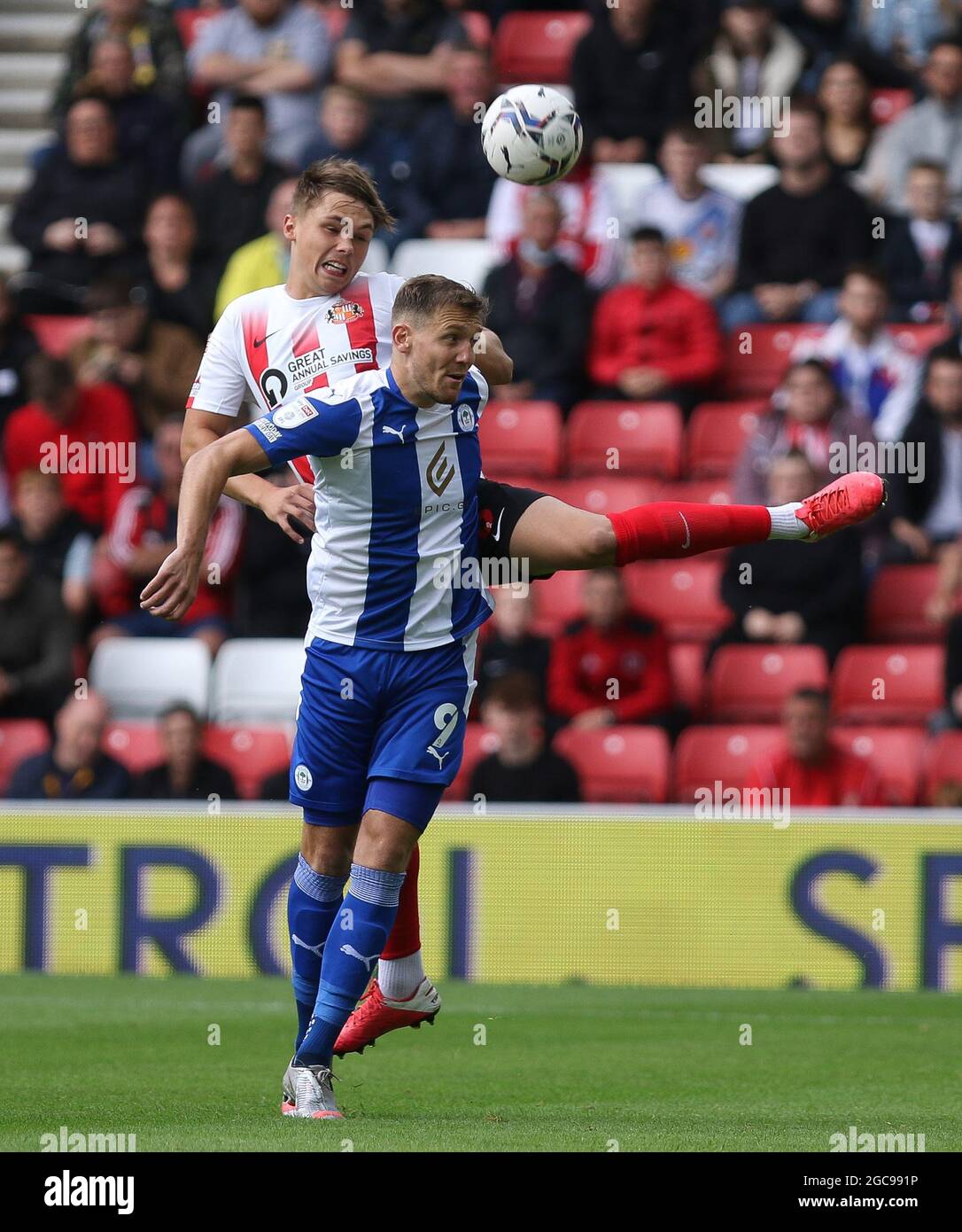 SUNDERLAND, UK. AUG 7TH Callum Doyle of Sunderland and Charlie Wyke of Wigan Athletic in action during the Sky Bet League 1 match between Sunderland and Wigan Athletic at the Stadium Of Light, Sunderland on Saturday 7th August 2021. (Credit: Will Matthews | MI News) Credit: MI News & Sport /Alamy Live News Stock Photo