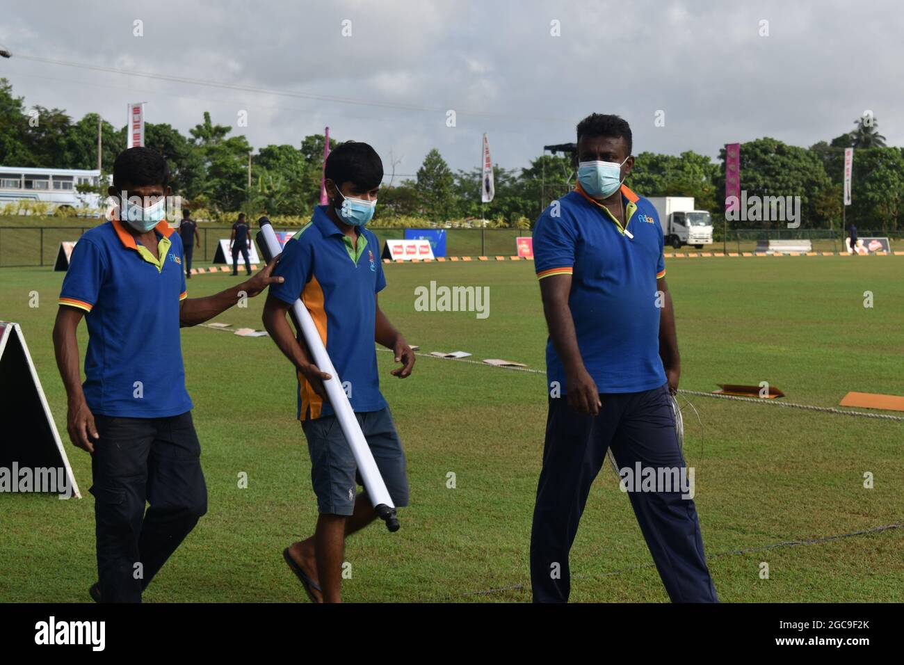 Ground staff at the picturesque Army Ordinance cricket grounds. Dombagoda. Sri Lanka. Stock Photo
