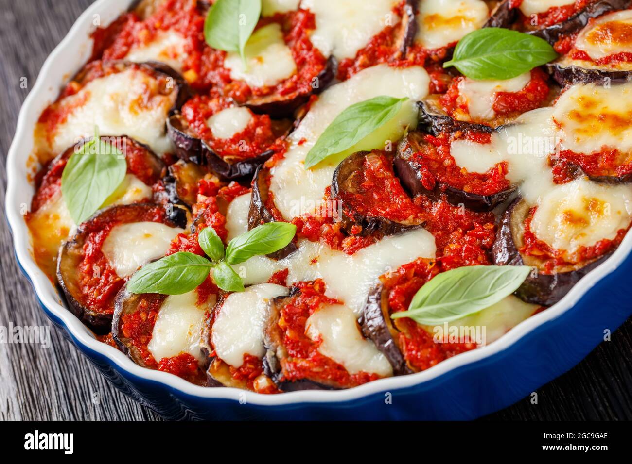 close-up of eggplant parmigiana, aubergine baked in a dish with tomato  sauce, basil, parmesan and mozzarella cheese, italian cuisine Stock Photo -  Alamy