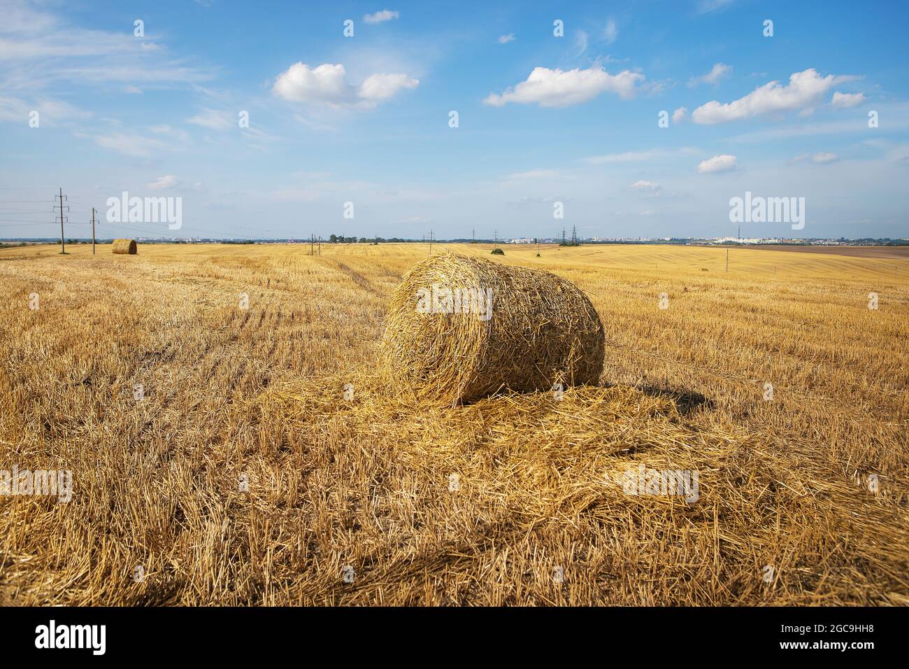Straw bales on farmland with blue beautiful sky with clouds Stock Photo ...