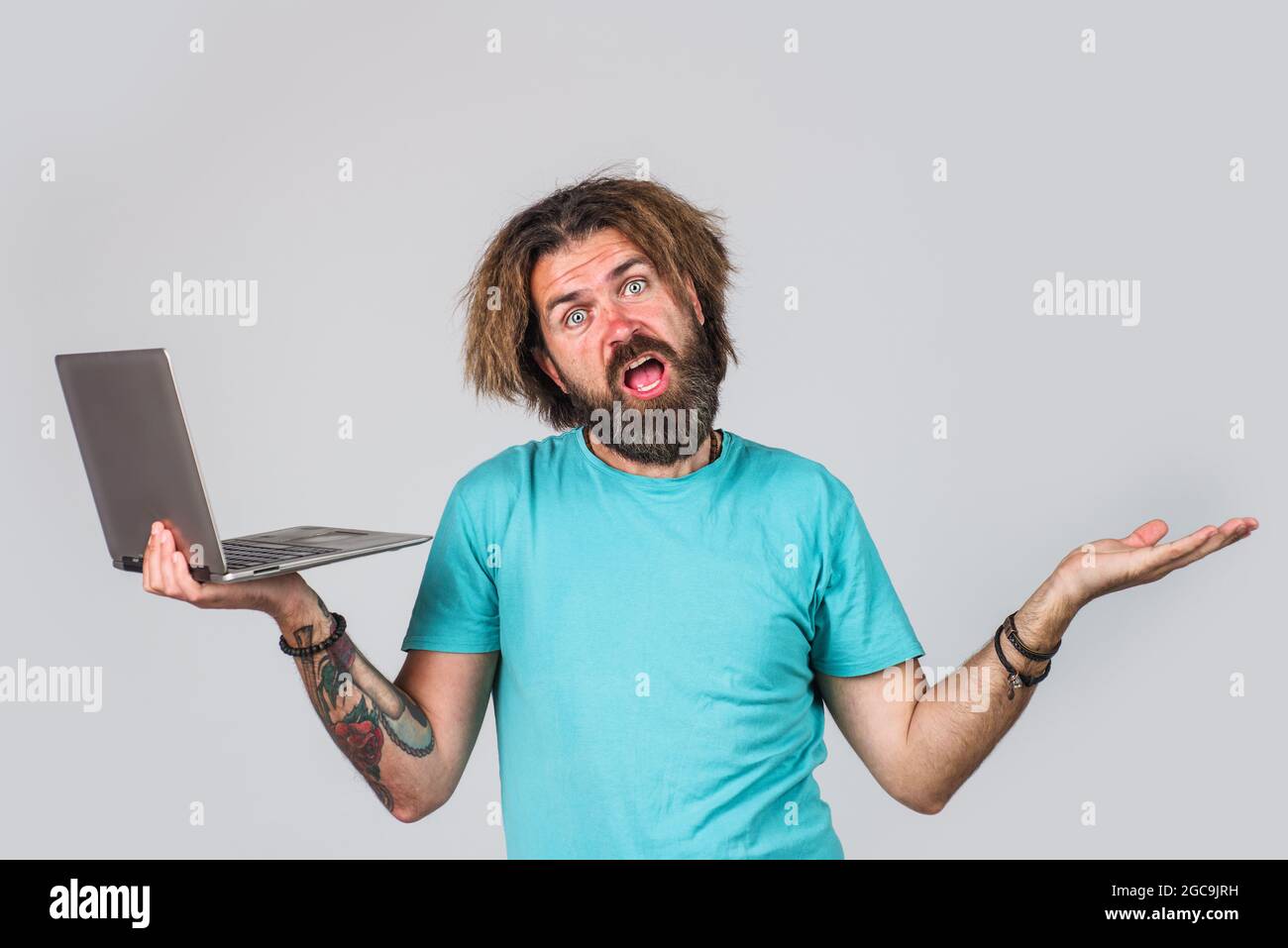 Bearded man with laptop. Digital device. Serious Business man with computer. Work from home. Stock Photo