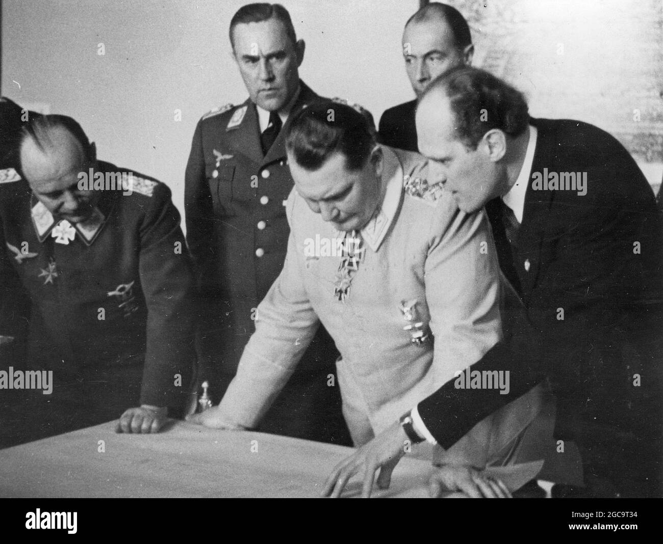 Hermann Goring  looking at sketches with General Ernst Udet (1st left), Karl Bodenschatz (2nd left) and Wilhelm Messerschmitt ( right). Stock Photo