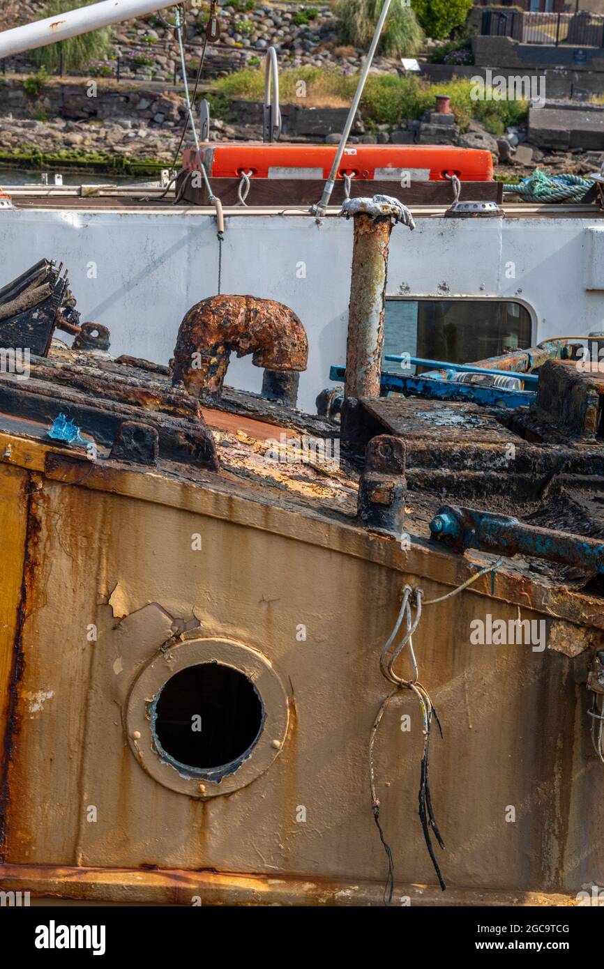 shipwreck, derelict old boat, dereliction, rust old ship, corroded old boat, old fishing trawler, old wreck of a boat, rusting away, salt water rust. Stock Photo