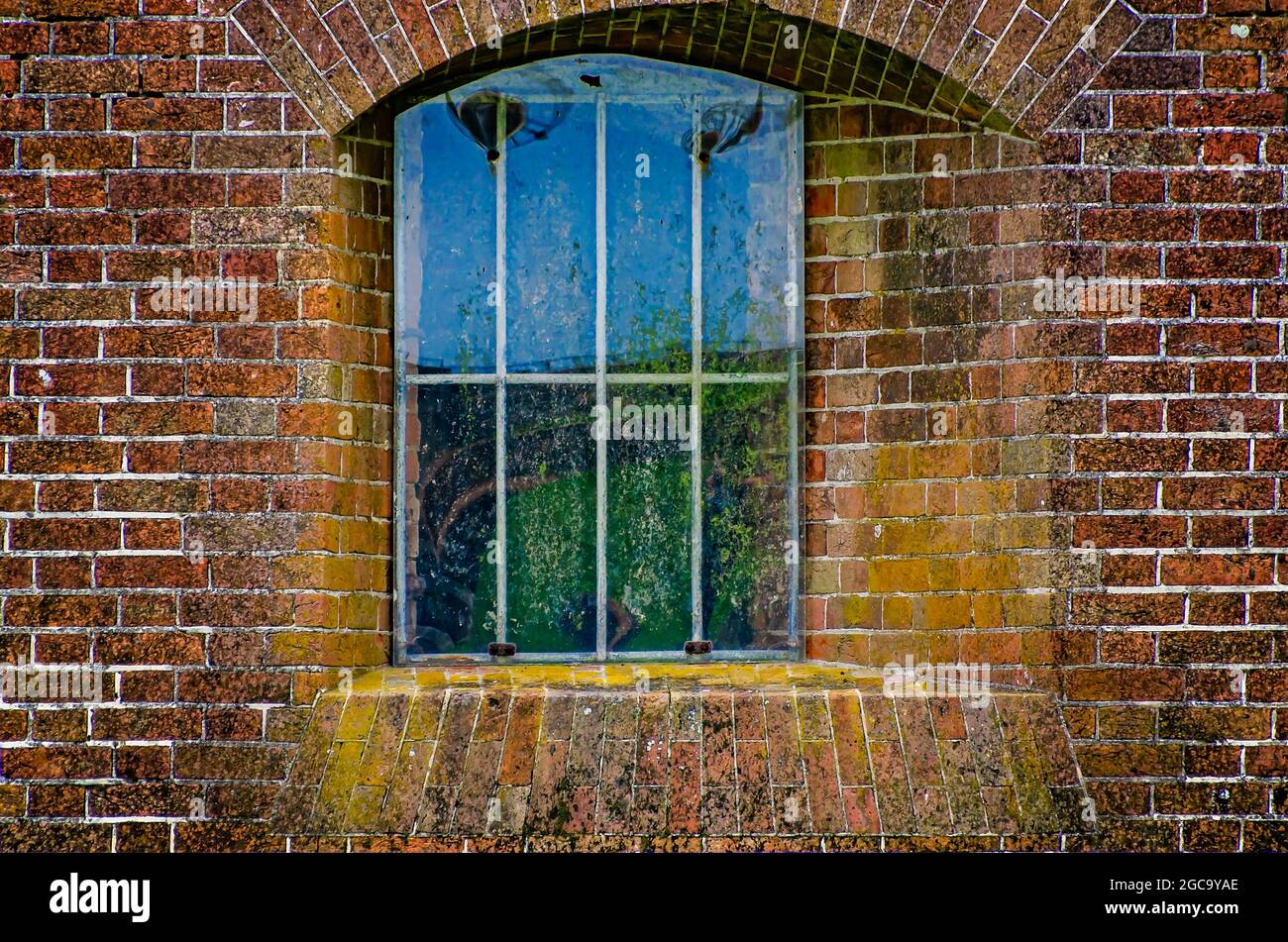 A window in the casemate allows space for a gun at Fort Morgan, July 31, 2021, in Gulf Shores, Alabama. Fort Morgan was built in 1834. Stock Photo