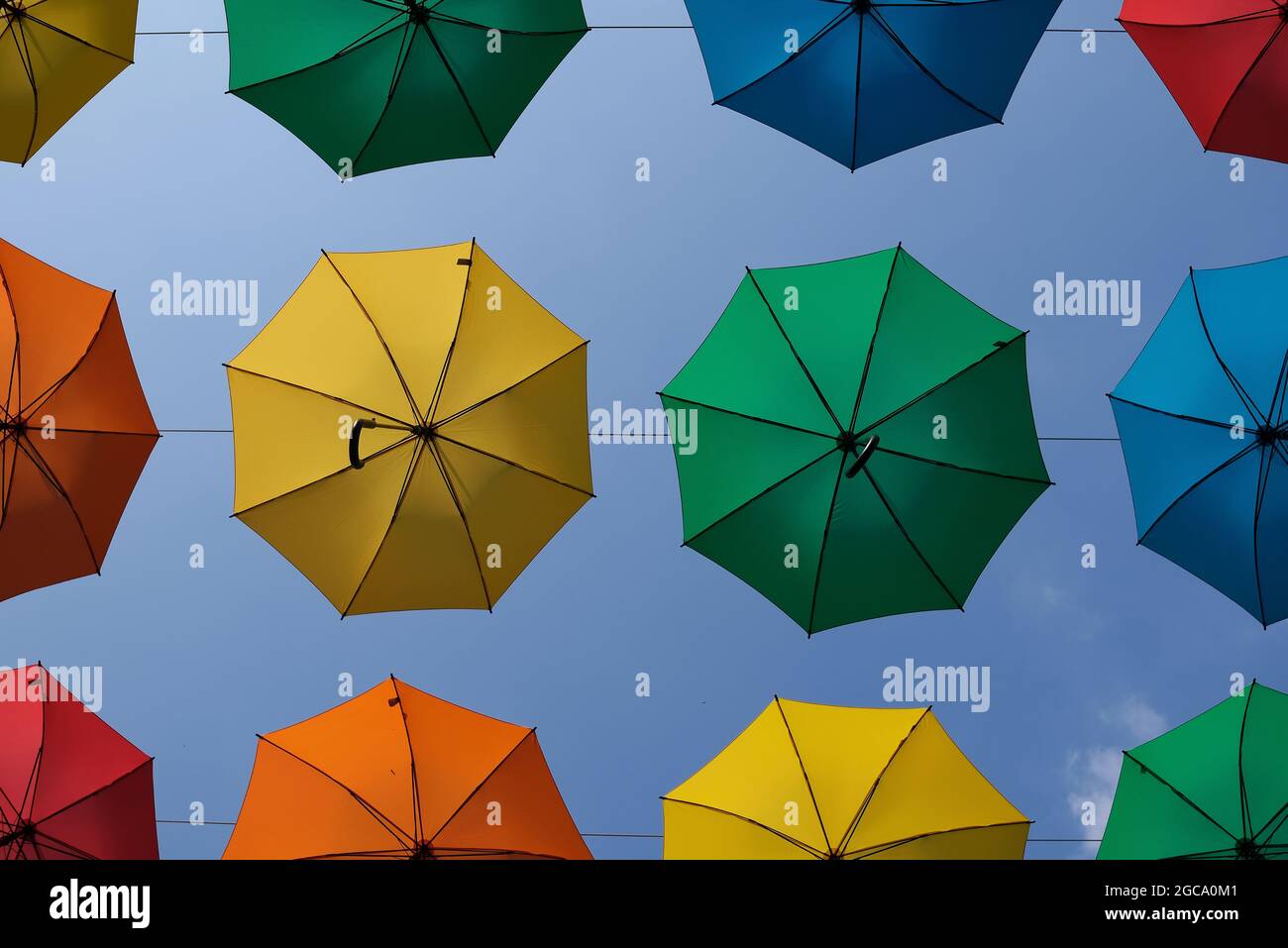 Colorful hanging umbrellas and a blue sky in the backround Stock Photo