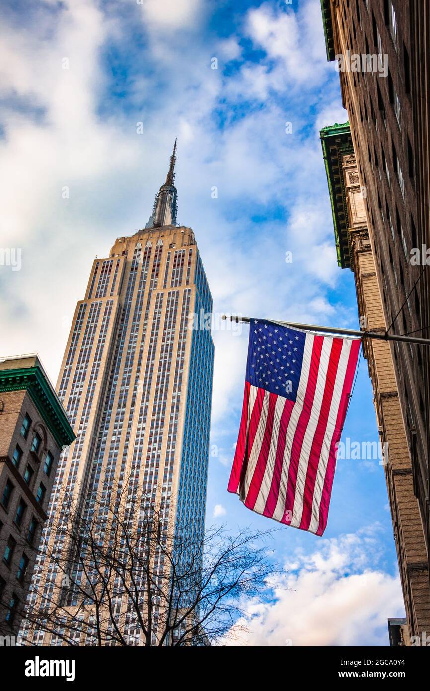 Empire State Building and US Flag from Fifth Avenue, New York City, NY, USA Stock Photo
