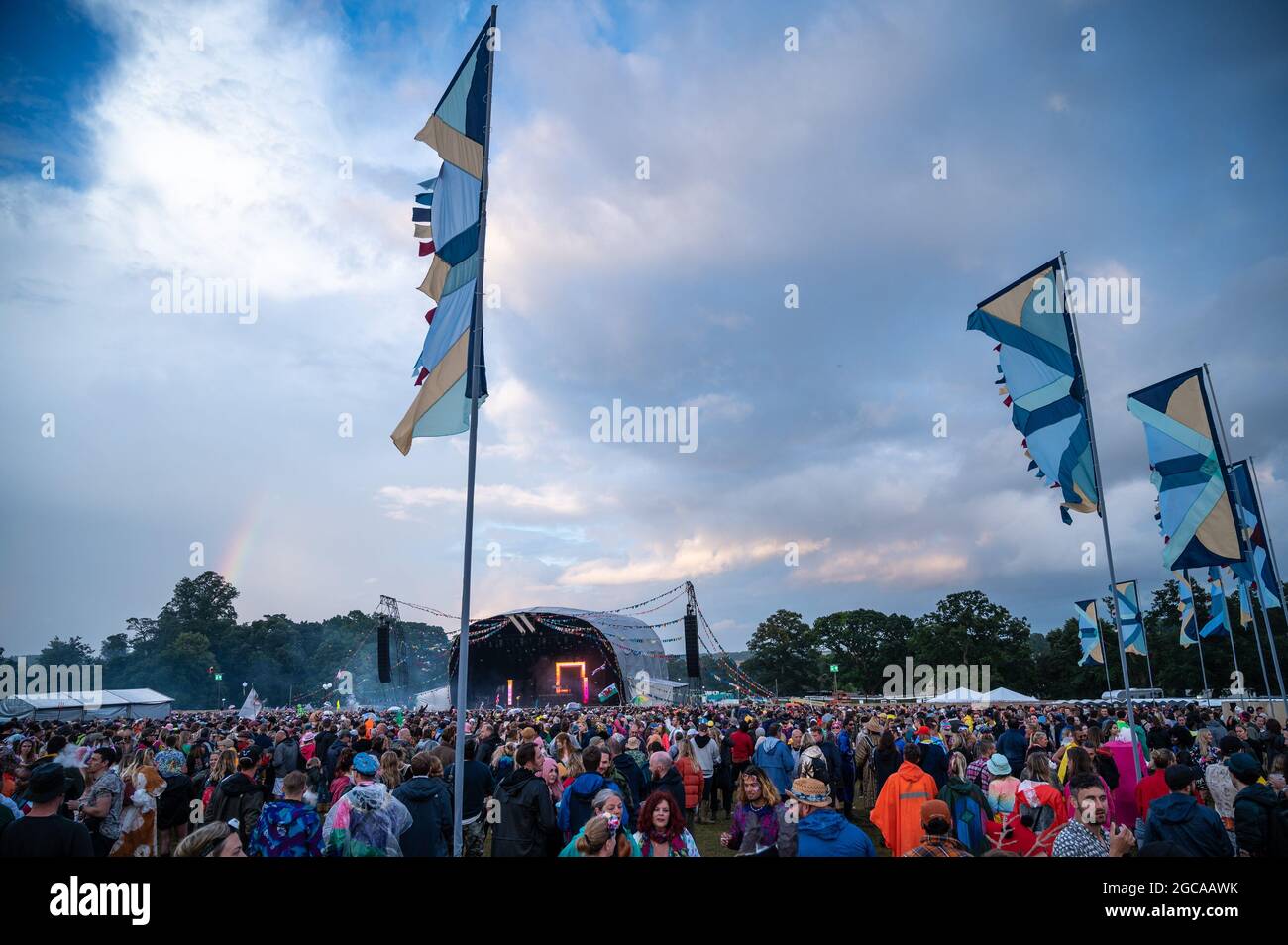 Wilderness Festival, Oxfordshire, UK. 7th Aug, 2021. Revellers enjoy Wilderness Festival despite a day filled with heavy downpours. It was postponed in 2020 due to Covid, but has been able to go ahead in 2021 with strict testing in place. Credit: Andrew Walmsley/Alamy Live News Stock Photo