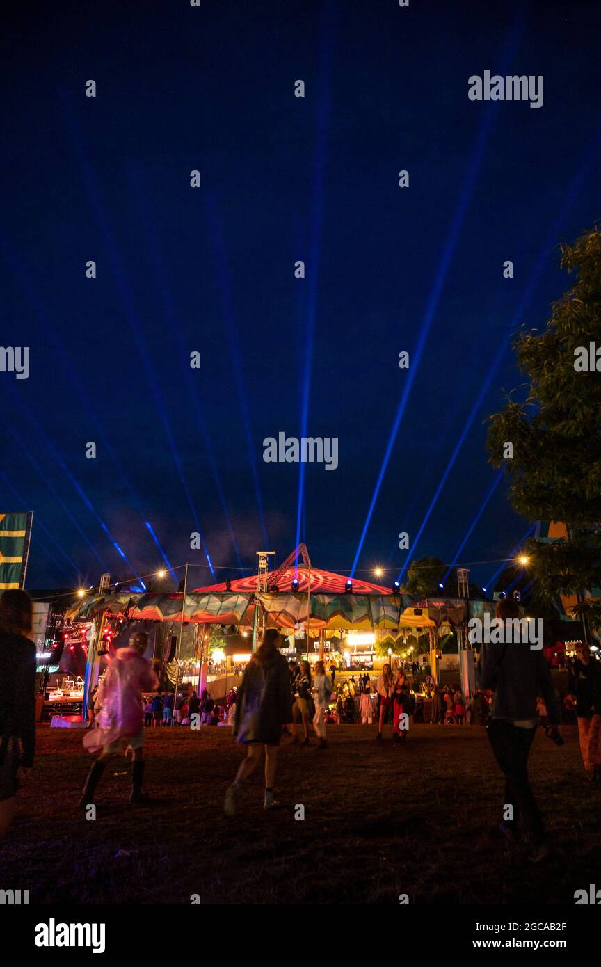 Wilderness Festival, Oxfordshire, UK. 7th Aug, 2021. Revellers enjoy Wilderness Festival despite a day filled with heavy downpours. It was postponed in 2020 due to Covid, but has been able to go ahead in 2021 with strict testing in place. Credit: Andrew Walmsley/Alamy Live News Stock Photo