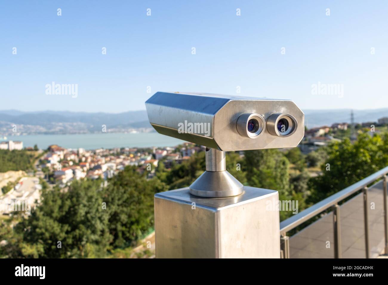 Touristic coin operated telescope binoculars look at the city landscape view Stock Photo