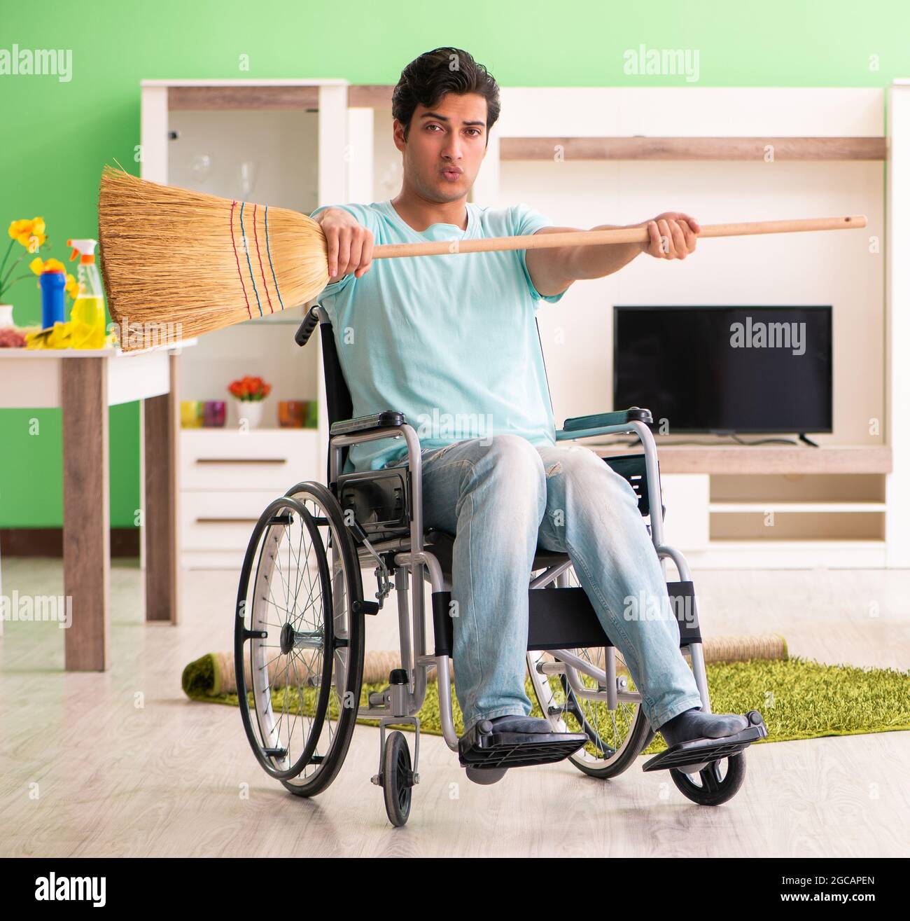 The disabled man on wheelchair cleaning house Stock Photo Alamy