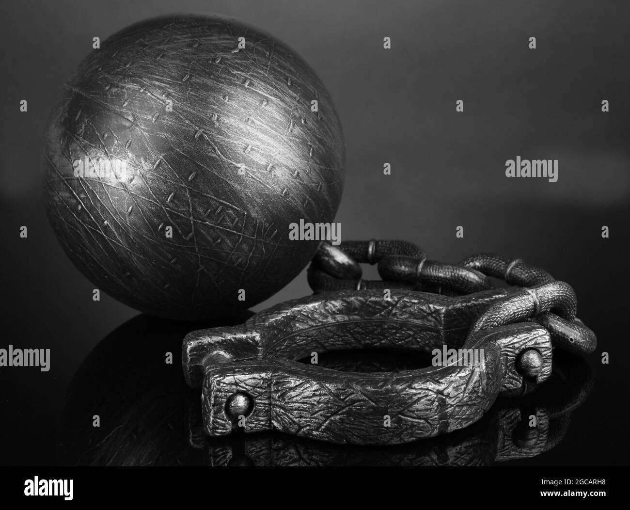 Ball and chain on grey background Stock Photo Alamy