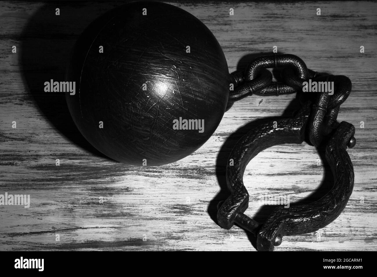 Ball and chain on wooden background Stock Photo Alamy