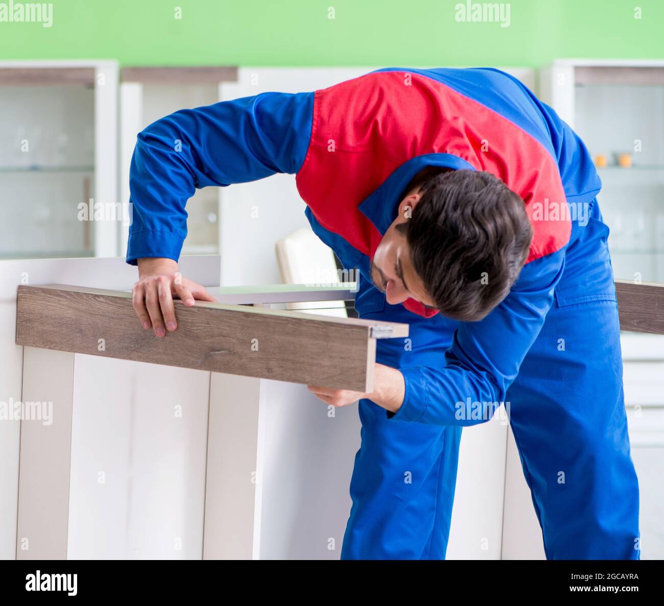 The repair contractor repairing broken furniture at home Stock Photo