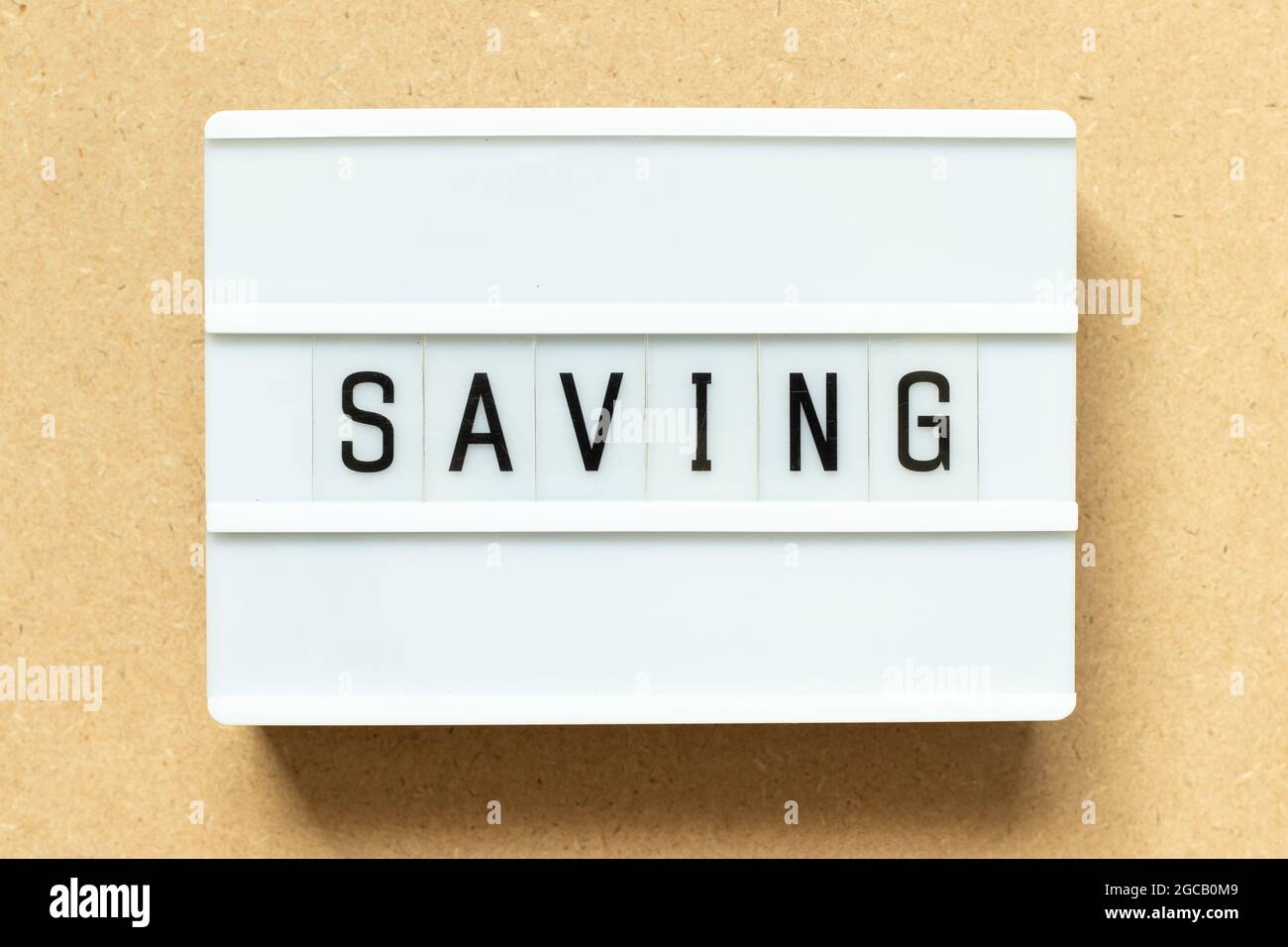 Lightbox with word saving on wood background Stock Photo