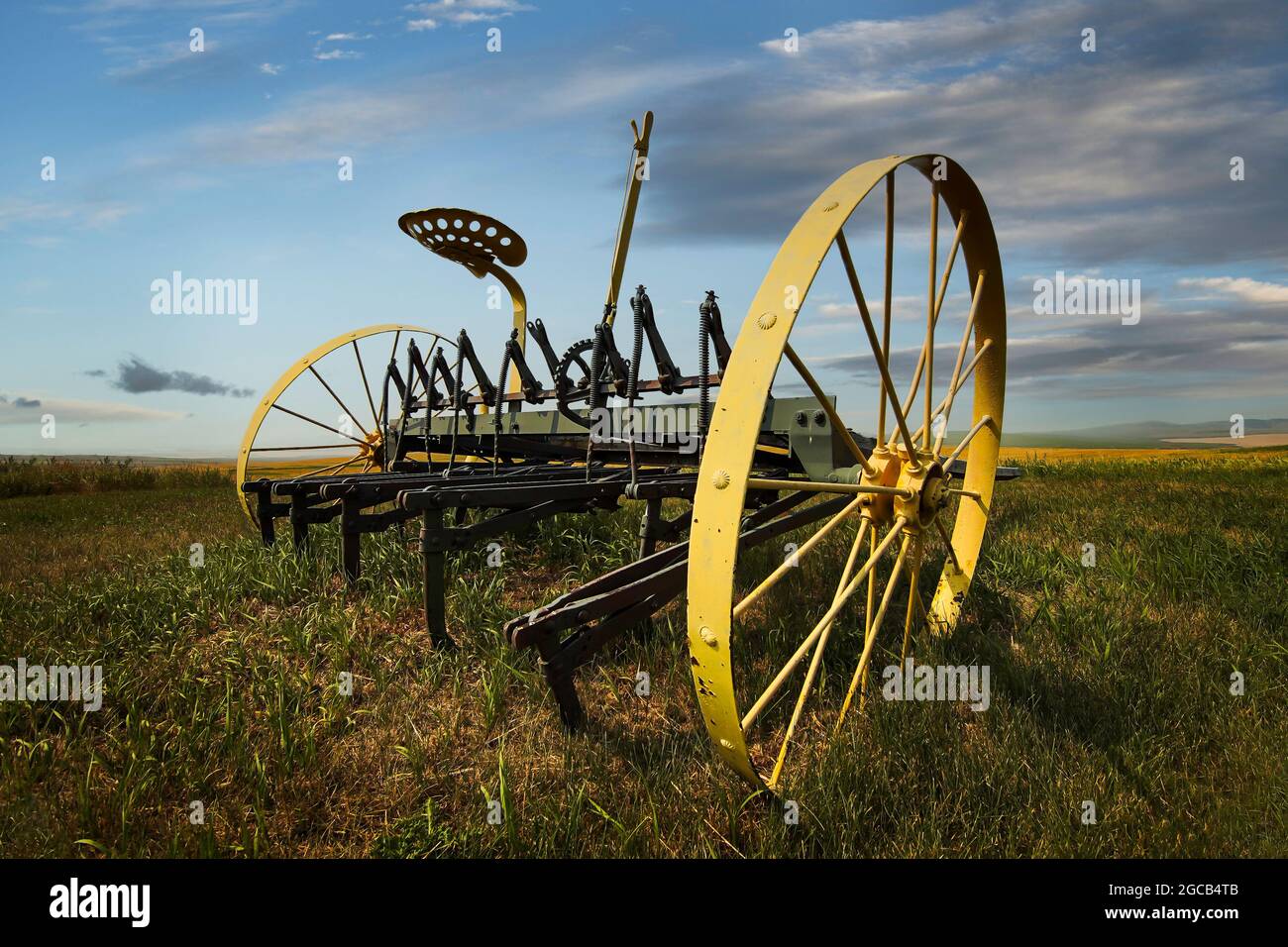 A vintage piece of agriculture equipment on a Canadian prairies farm in Alberta Canada. Stock Photo