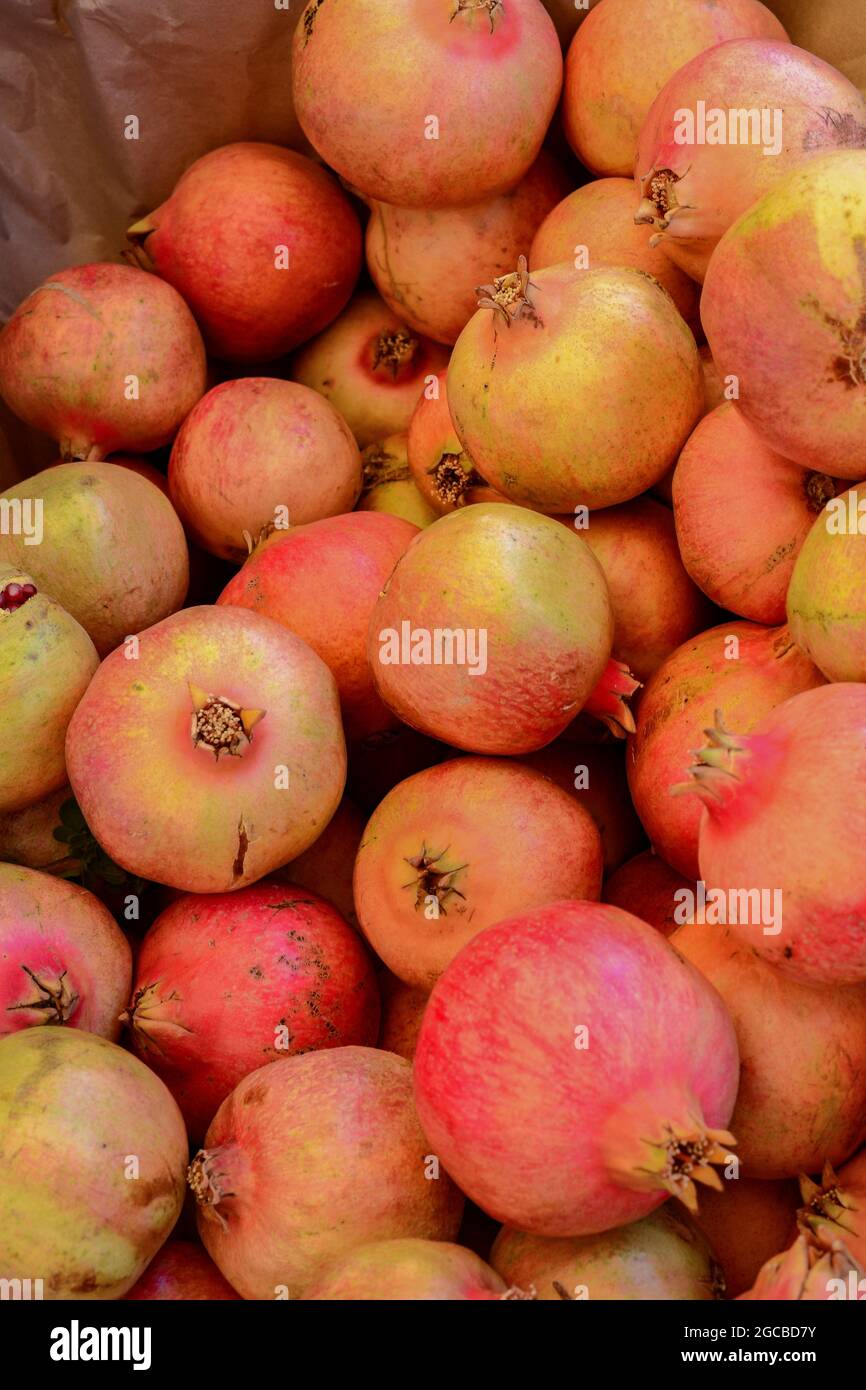 Fresh pomegranates in a market basket Stock Photo