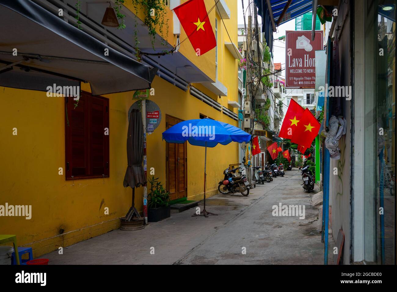 National Day in Vietnam - flag hung in front of houses in a small alley in the city of Nha Trang.  Nha Trang, Vietnam: 2020-10-13 Stock Photo