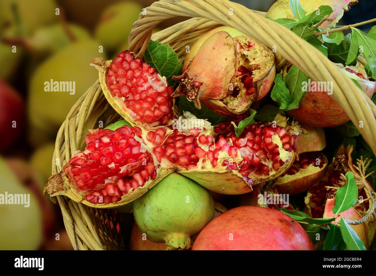 Fresh pomegranates in a market basket Stock Photo