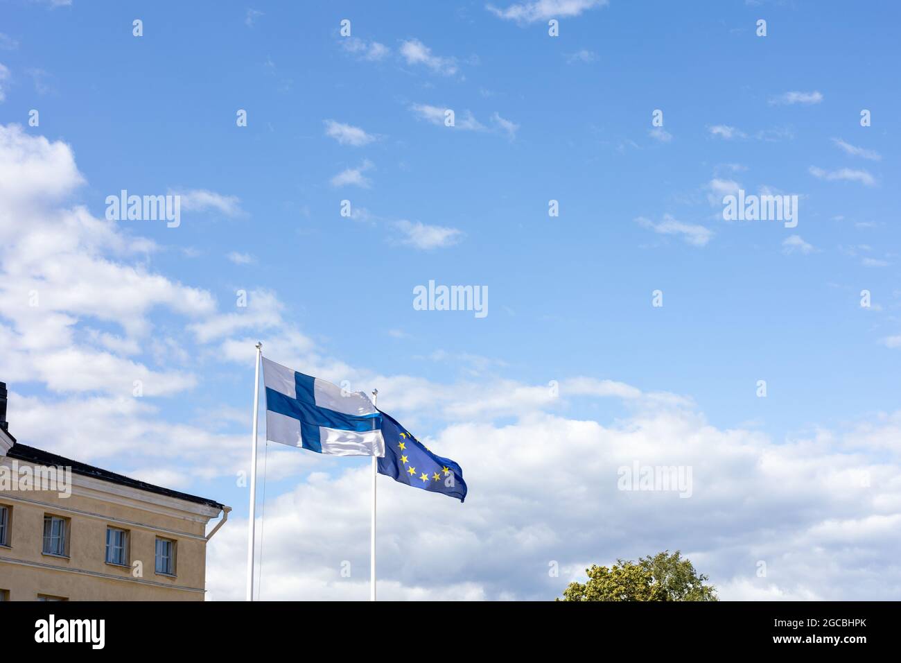The Finnish and EU flags flapping in the wind Stock Photo