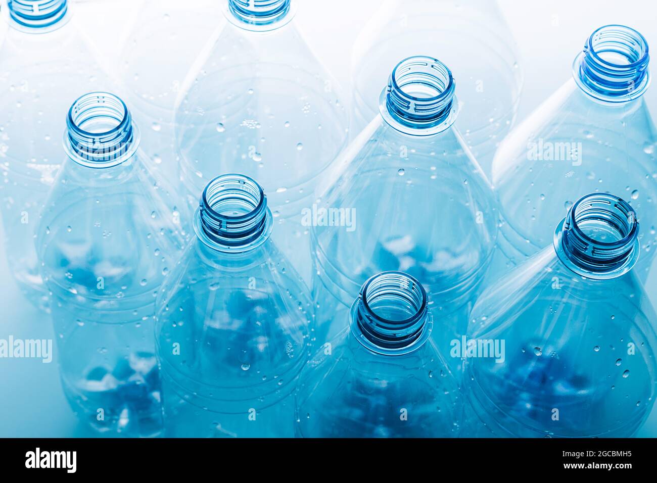 Empty plastic bottles on a blue background. Recycling recyclable