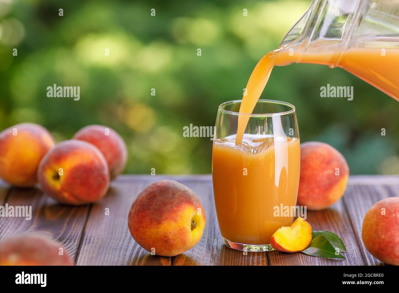 fresh peach juice pouring into glass outdoors Stock Photo Alamy
