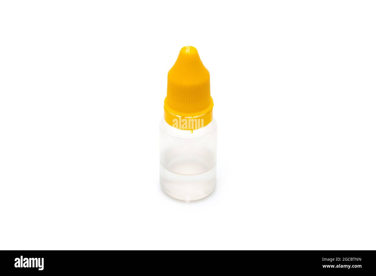Small transparent medicine bottle with a yellow cap on an isolated