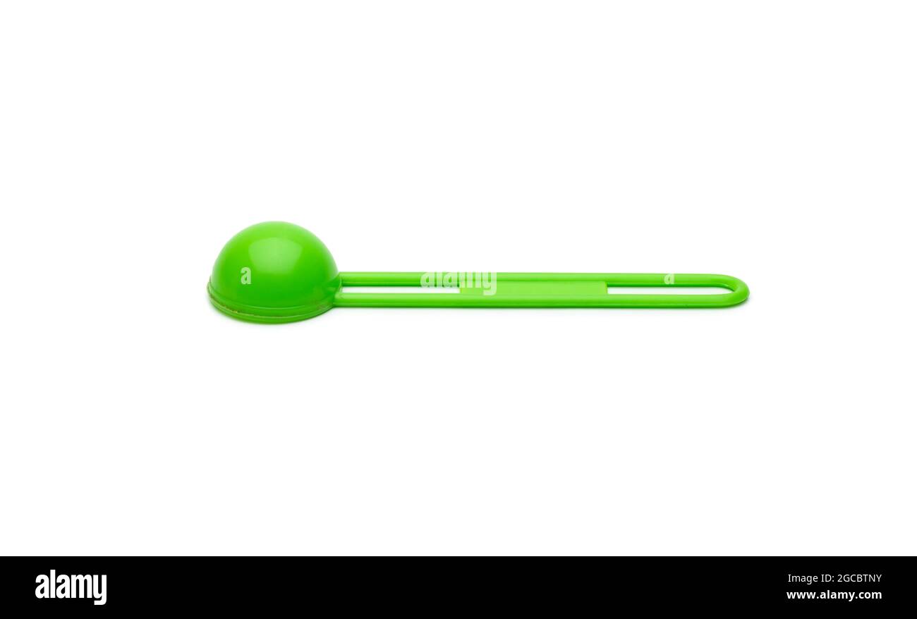 Isolated green measuring plastic spoon on white background Stock Photo