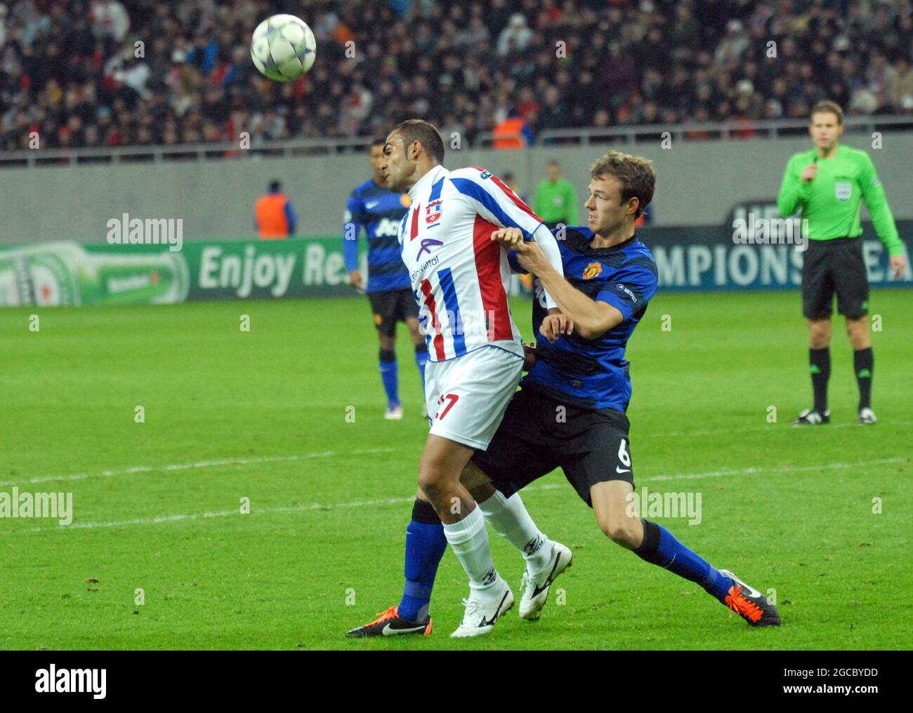 BUCHAREST, ROMANIA - OCTOBER 18, 2011: Marius Pena (L) of Otelul and Jonny Evans (R) of Manchester pictured during the UEFA Champions League Group C game between Otelul Galati and Manchester United at National Arena. Stock Photo