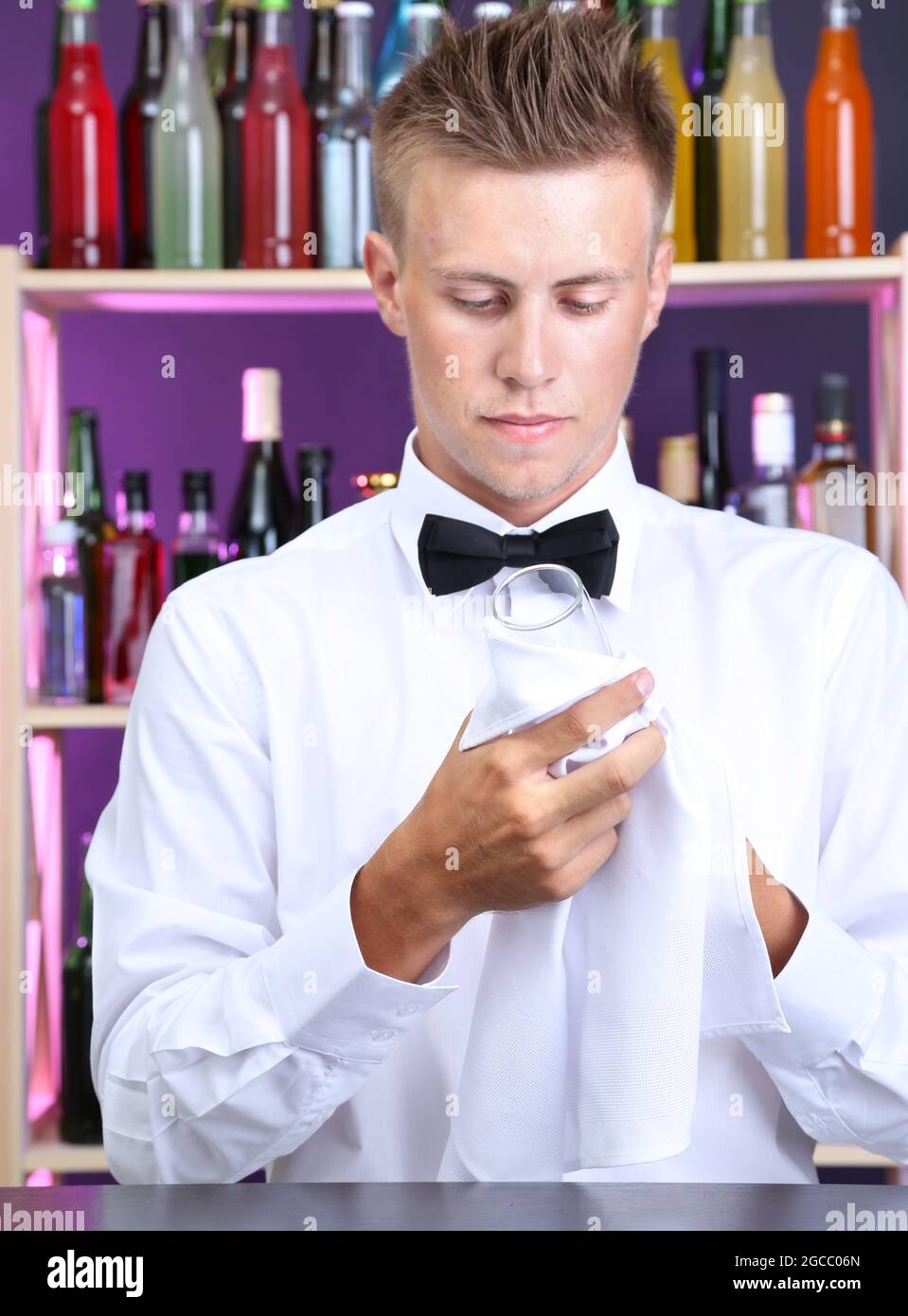 Bartender wipes glasses at work Stock Photo Alamy