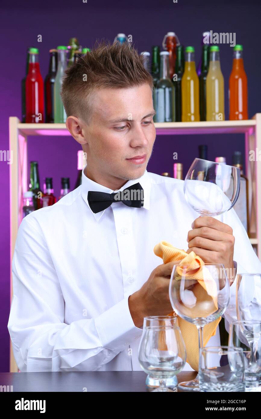 Bartender wipes glasses at work Stock Photo Alamy