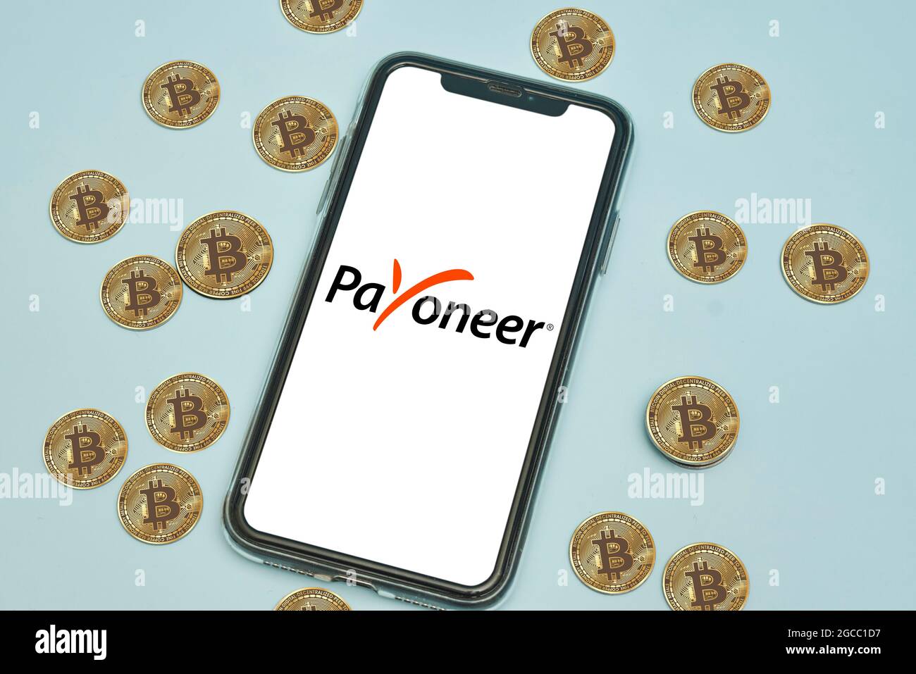 Tashkent, Uzbekistan - April 2, 2021: Payoneer logo on mobile phone screen  and pile of bitcoins cryptocurrency. Symbol of cryptocurrency rolling out  Stock Photo - Alamy