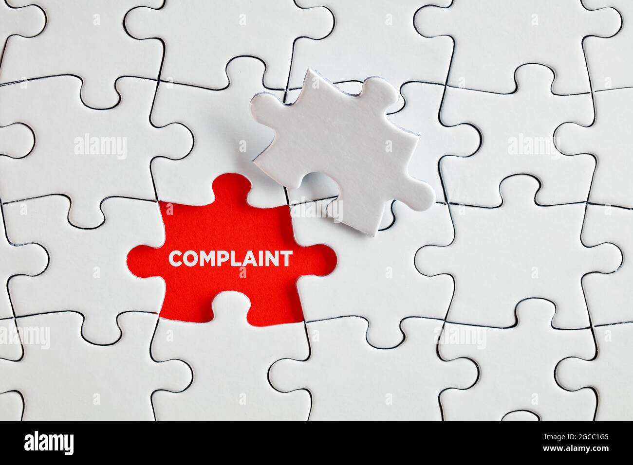 The word complaint on the missing puzzle piece. To discover or expose customer complaints concept. Stock Photo