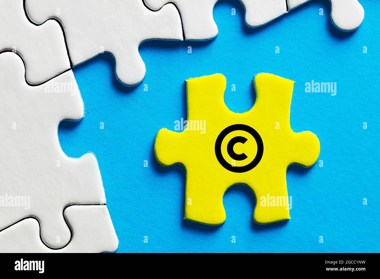 Copyright icon on a puzzle piece. Property and intellectual rights protection. Stock Photo