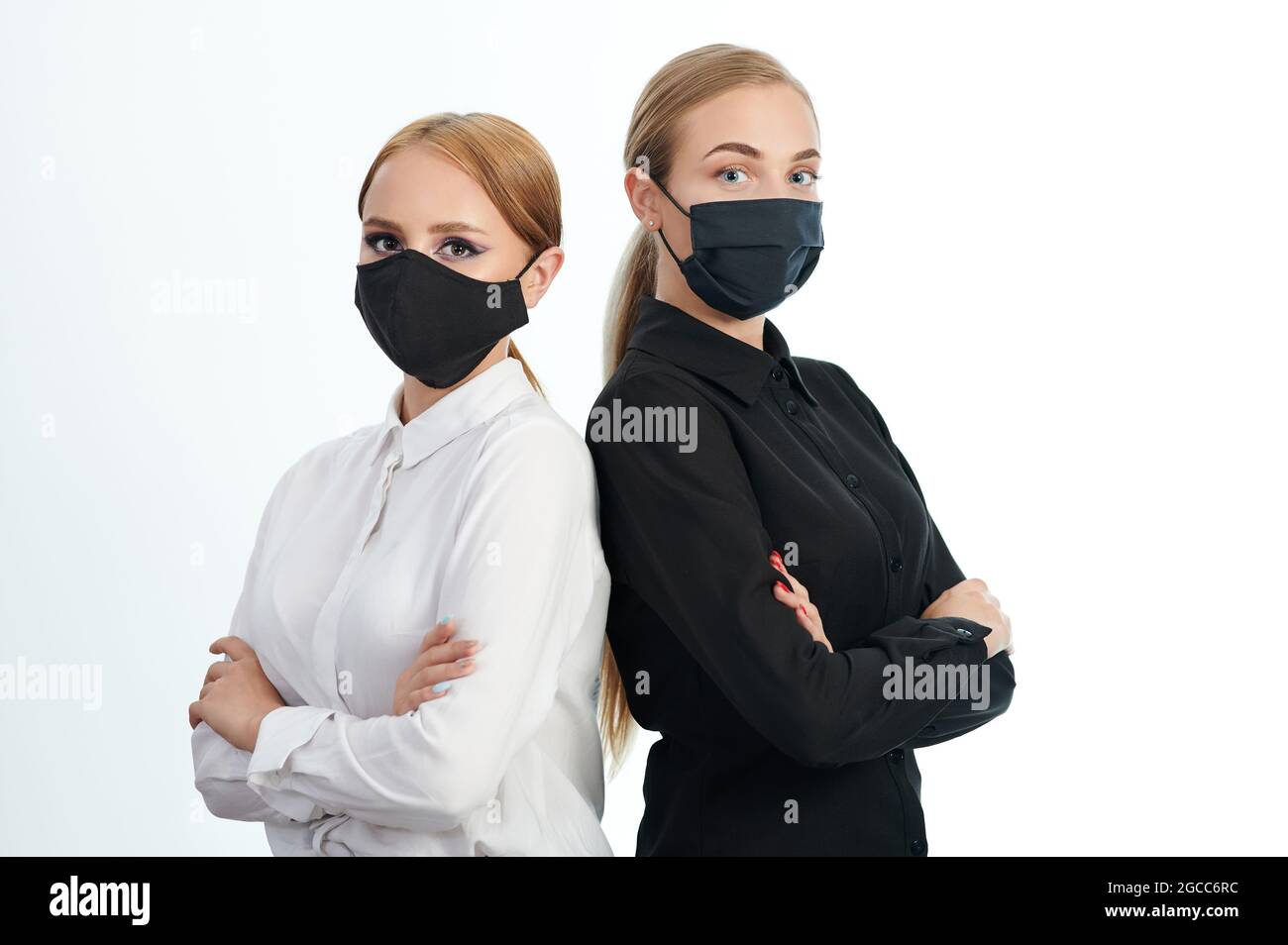 Young woman with cross hands in mask isolated on white studio background Stock Photo