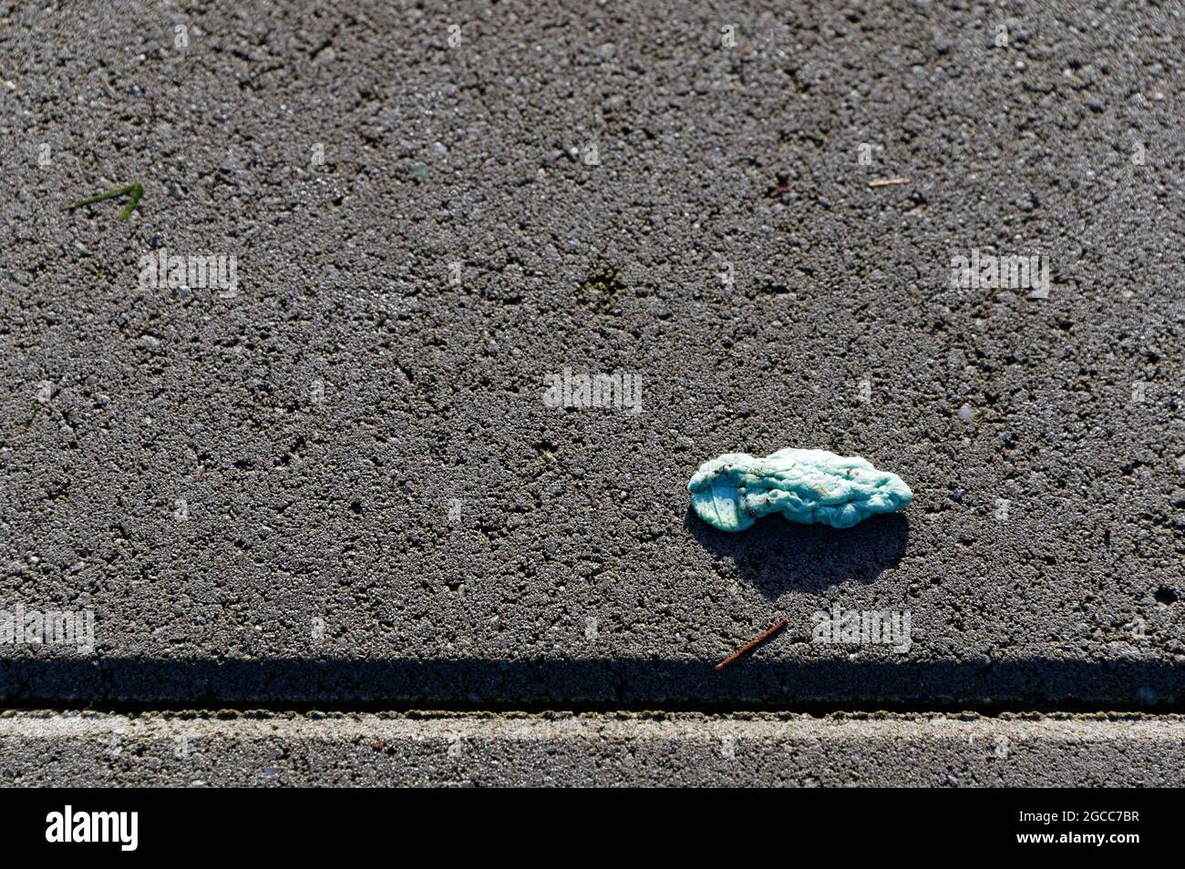 Chewing gum has been spat out onto a pavement Stock Photo