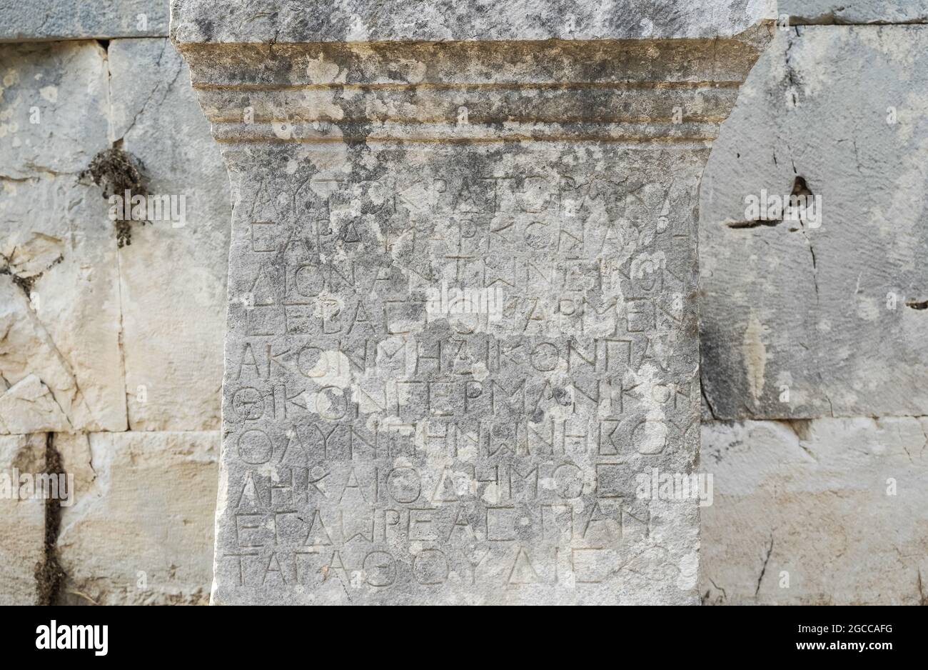 Antique greek inscriptions carved on the stone of the old ruins of an antique greek city. High quality photo Stock Photo