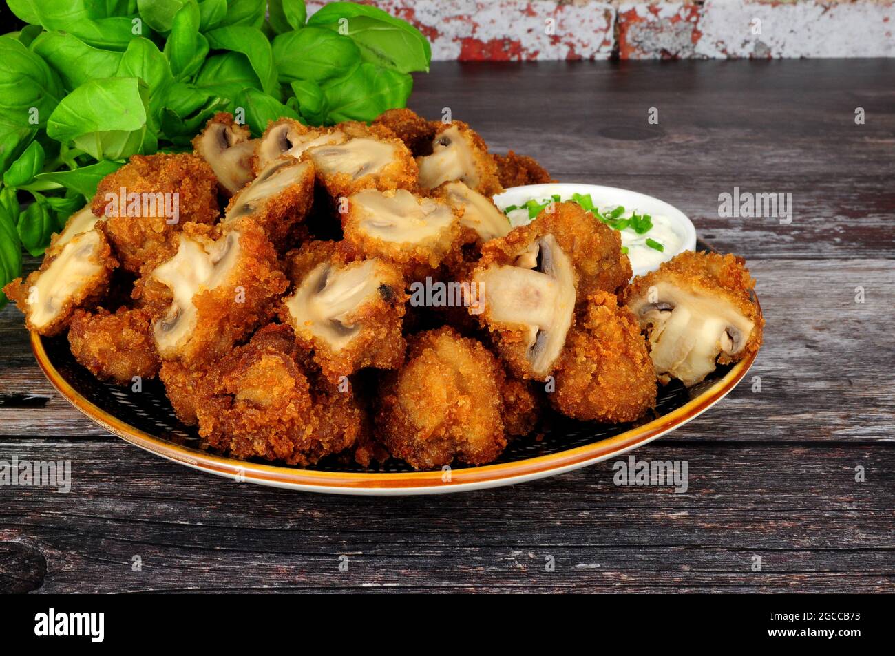 Whole breaded button mushrooms with soured cream and chive dip Stock