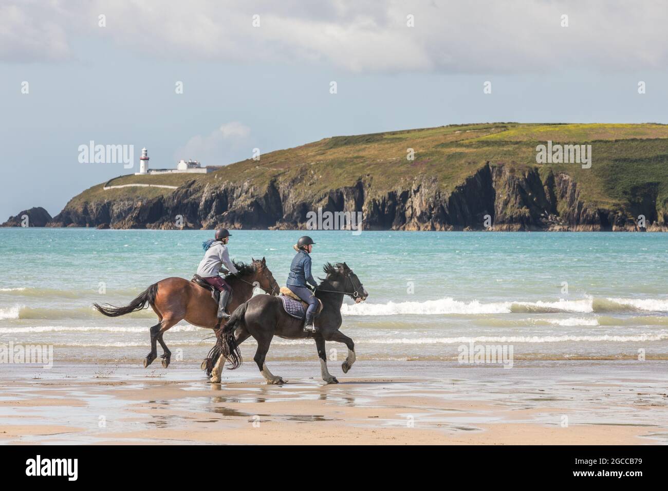 Red Strand, Cork, Ireland. 07th August, 2021.  Lauren Crowley on Esmeralda and Shannon McQueen on Oxbow go for an early morning gallop on Red Strand in West Cork, Ireland. - Picture; David Creedon / Alamy Live News Stock Photo