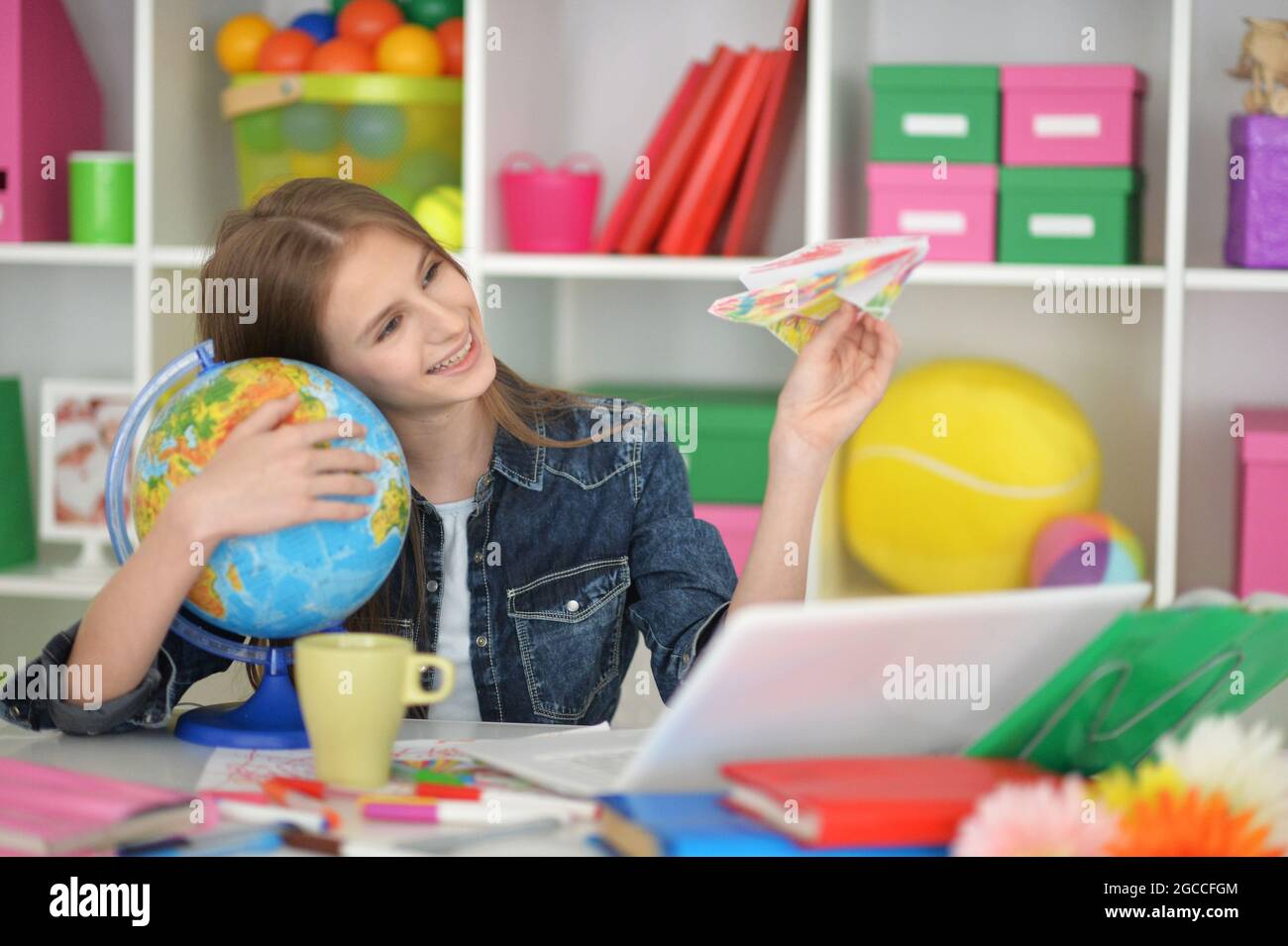 Cute girl studying at home at desk Stock Photo - Alamy