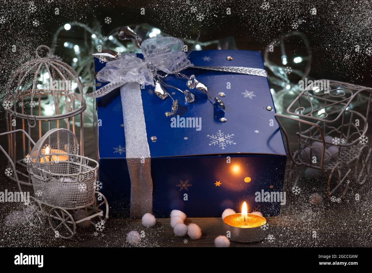 Christmas gift box with christmas decorations and lights in blue silver Stock Photo