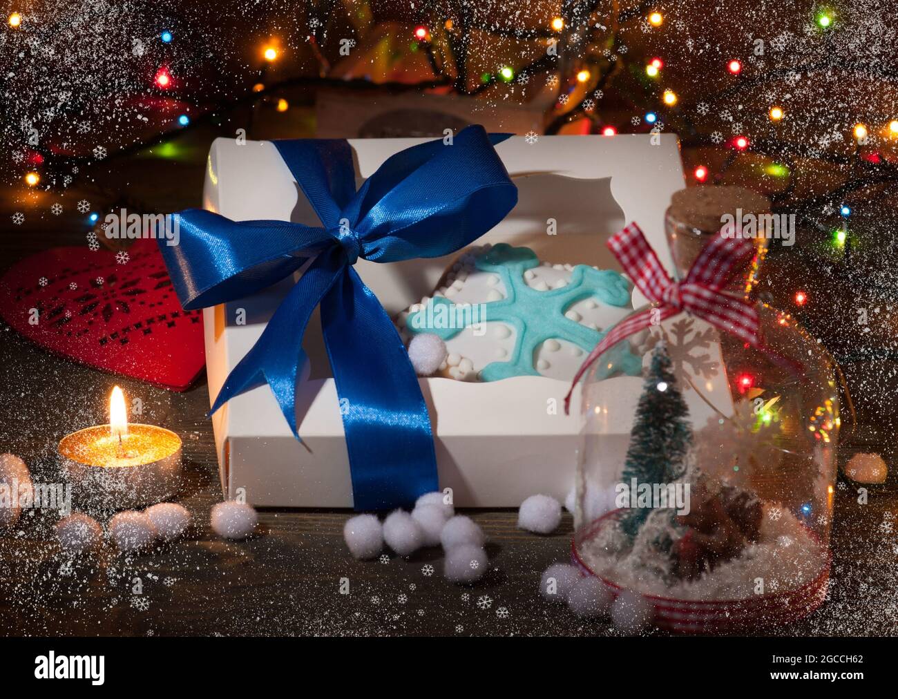 Christmas gift box with christmas decorations, gingerbread and lights