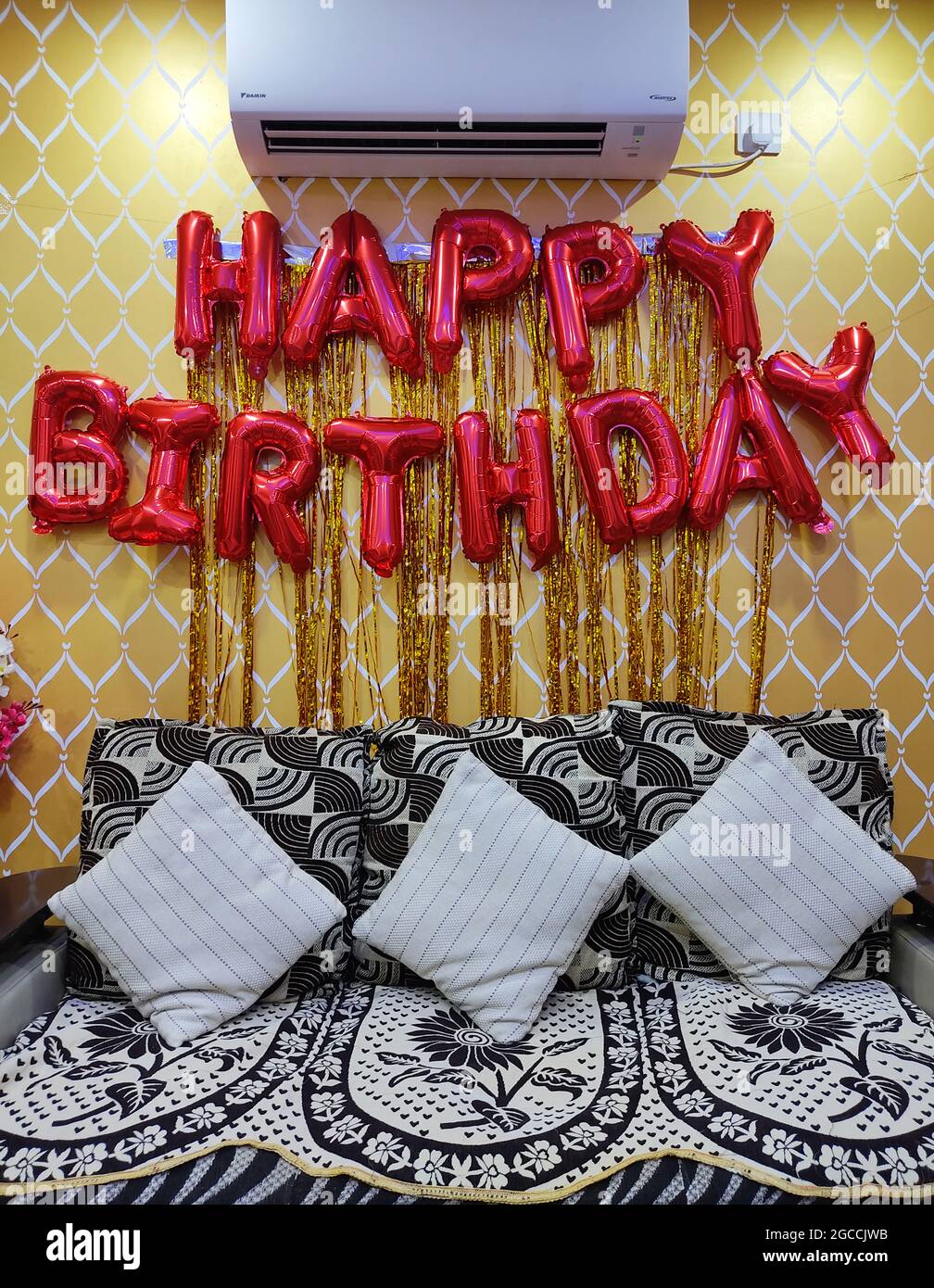 Happy Birthday Golden Balloon Hanging Banner on Wall. Birthday  Party Decorations. Home Interior. Stock Photo