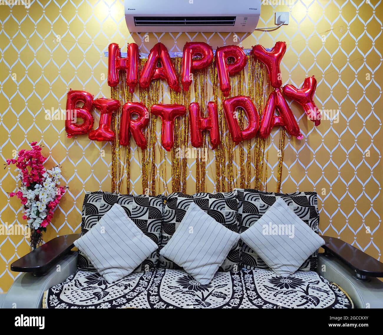 Happy Birthday Golden Balloon Hanging Banner on Wall. Birthday  Party Decorations. Home Interior. Stock Photo
